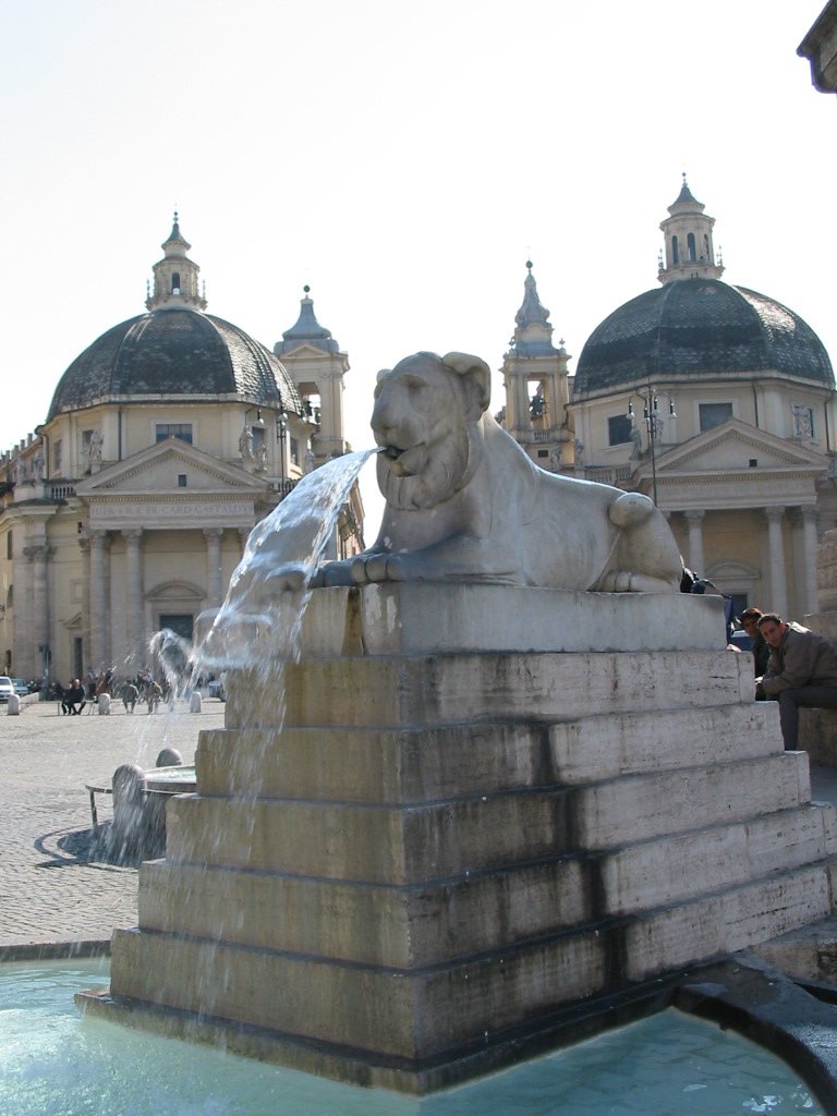 a fountain is running in front of an ornate building