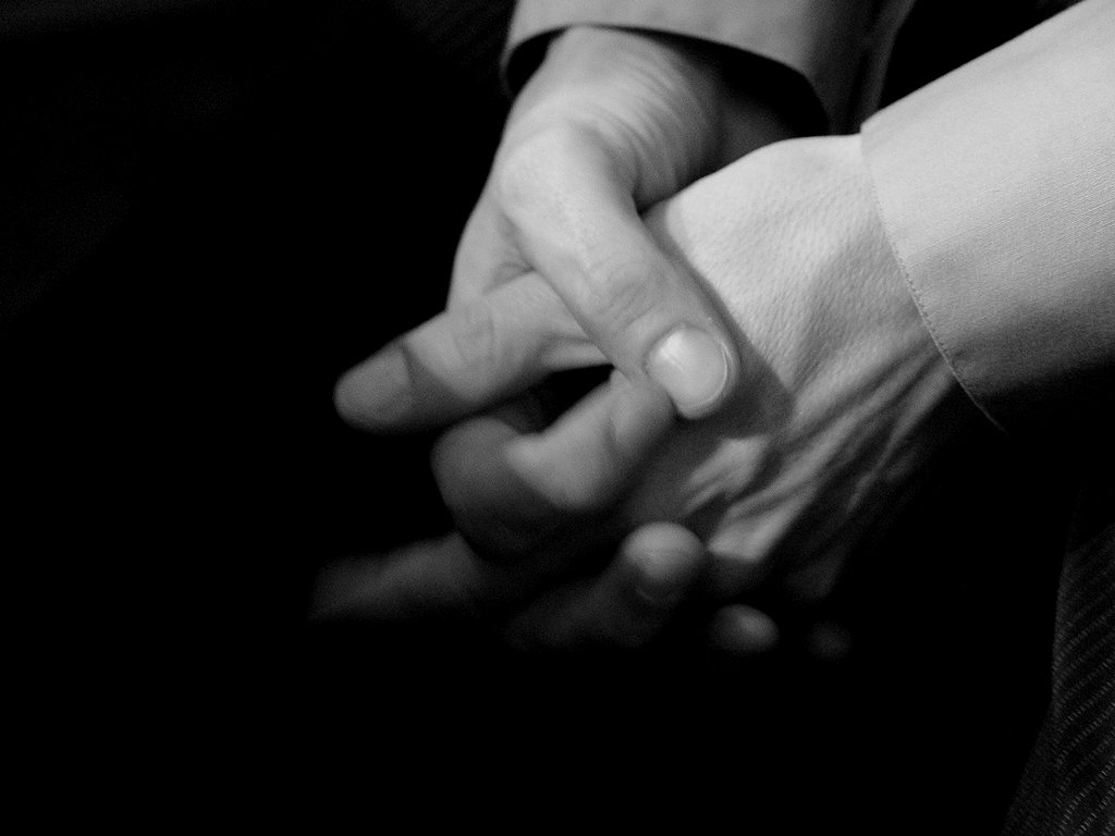 the couple is holding hands while wearing rings