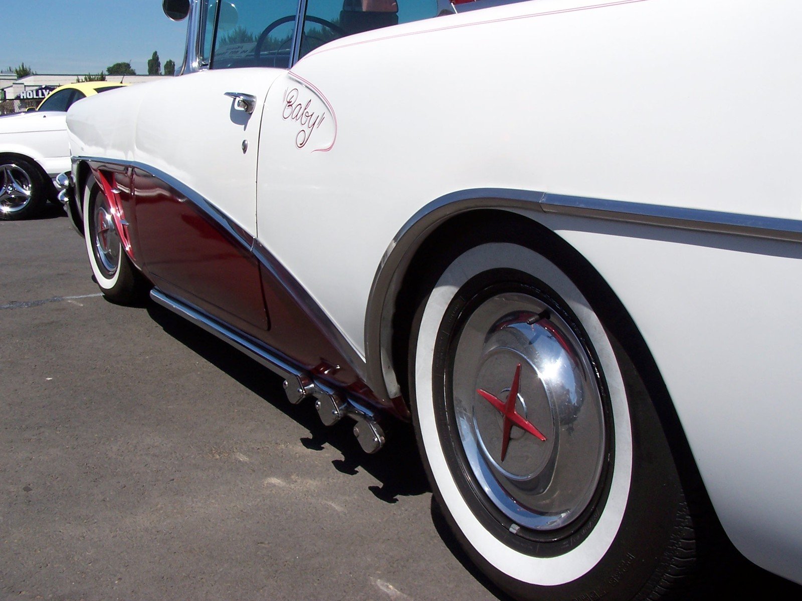 the rear end of an older fashioned white classic car