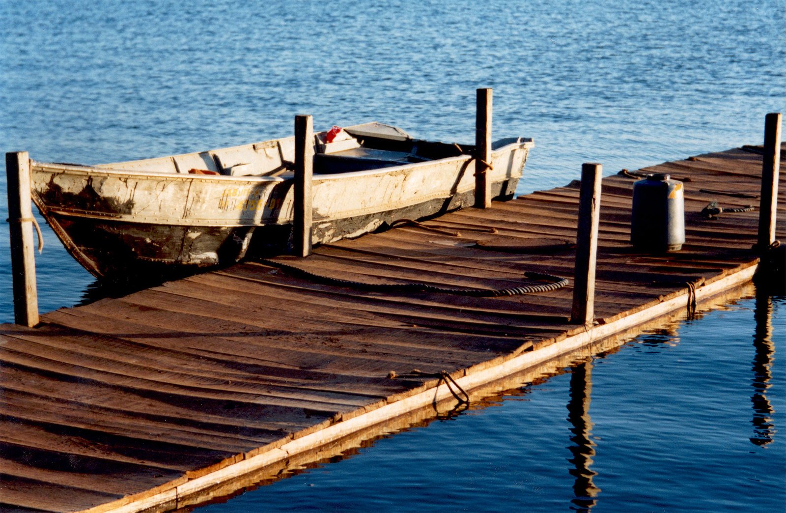 a boat is tied up to the dock by water