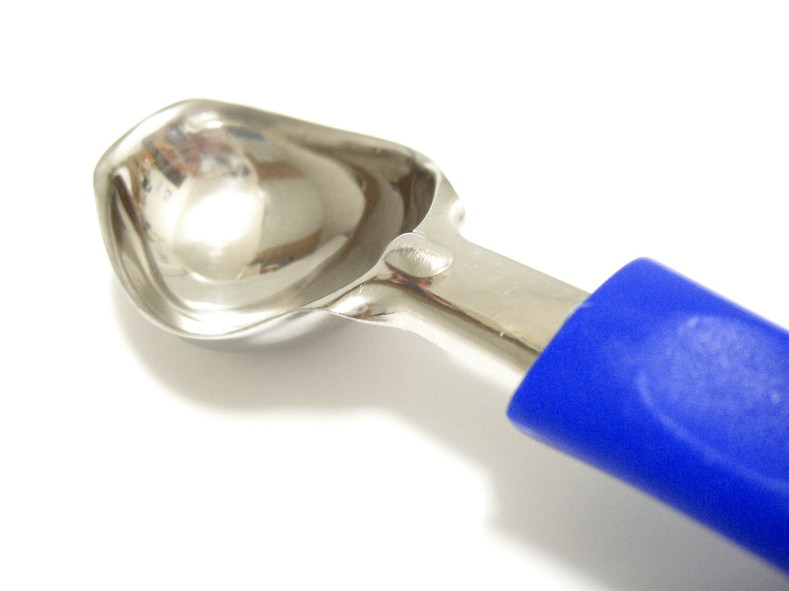 a plastic spoon on top of a plastic spatula