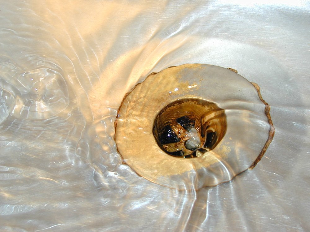 a close up s of a sink drain and white plastic