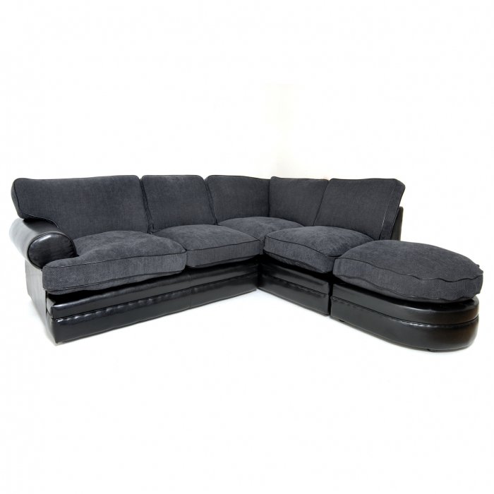 a large grey couch with an ottoman and ottoman