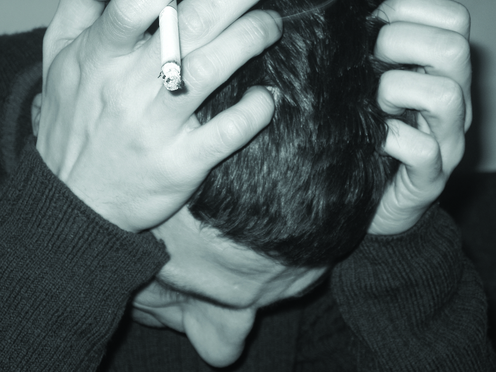 black and white pograph of a man smoking