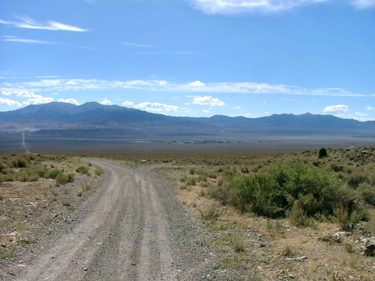 a view of a gravel road that runs into the distance