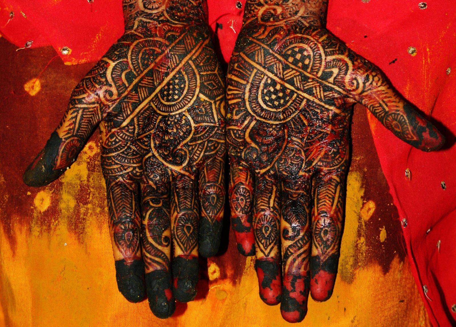 a hand with intricate designs that is on a person