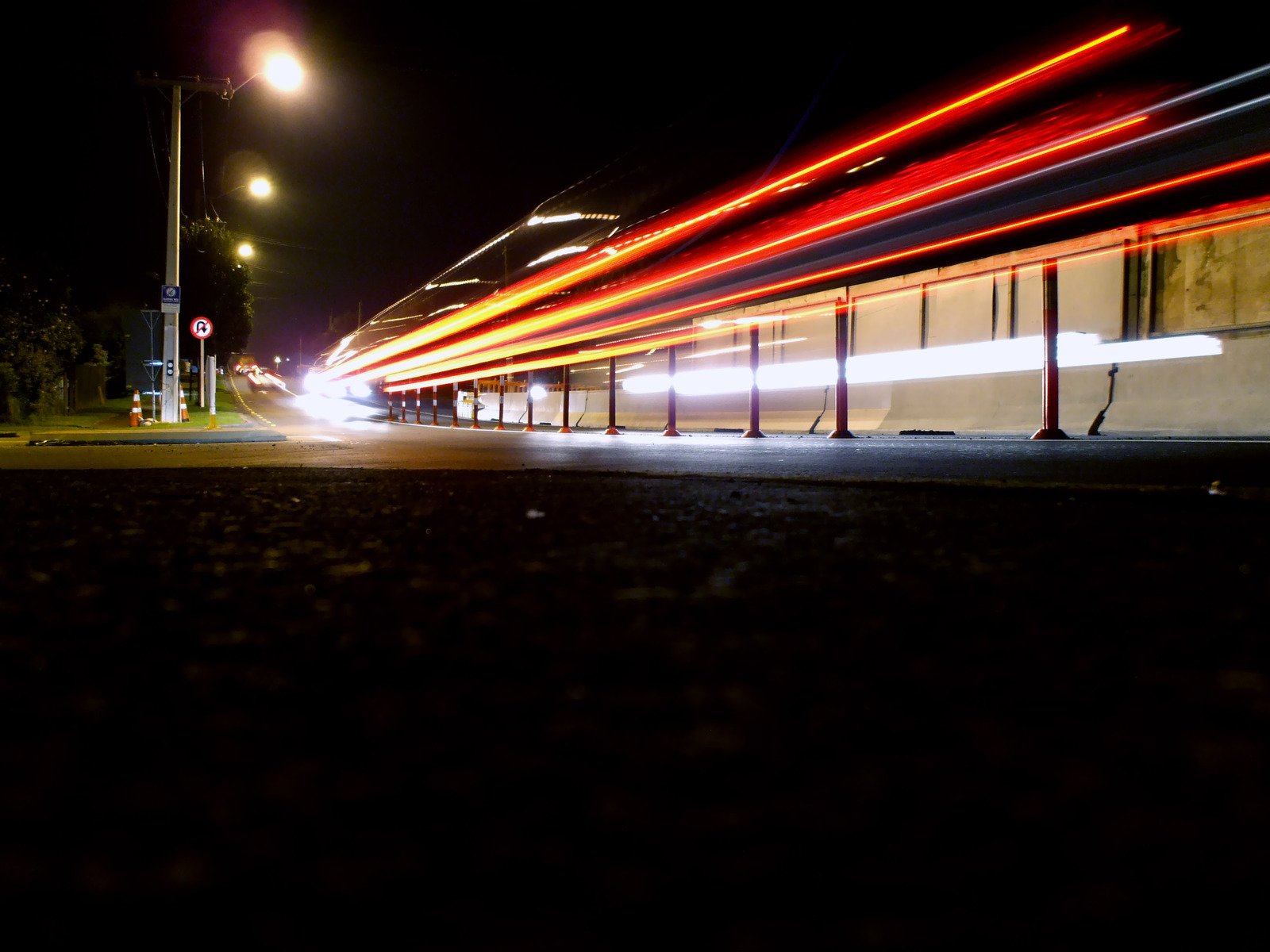 bright lights move along the street in front of a building