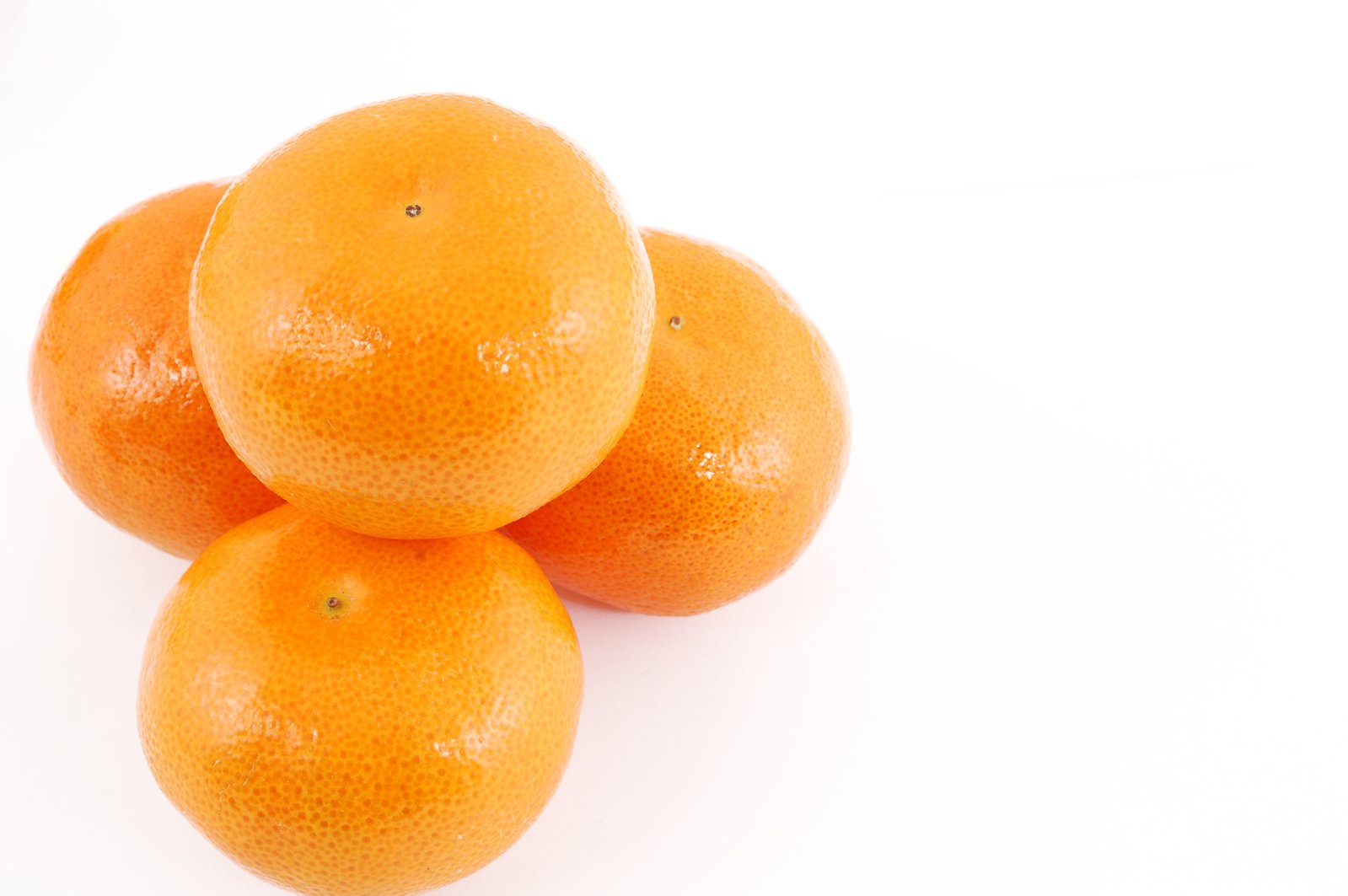 three oranges laying on top of each other