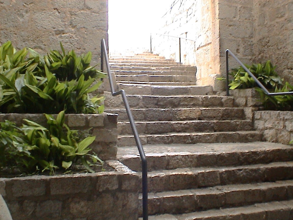 the stone stairs are going up to the bottom