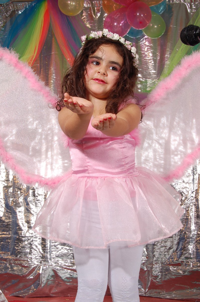 a child dressed up as an angel for her birthday