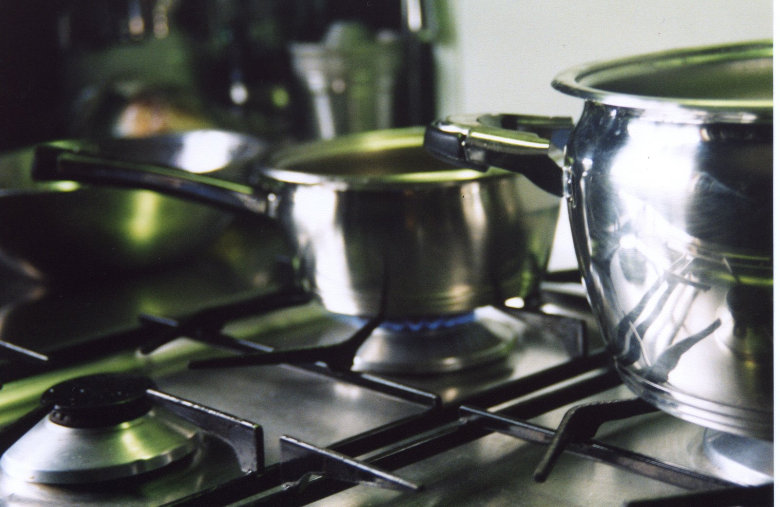 some shiny pots are cooking on a stove top