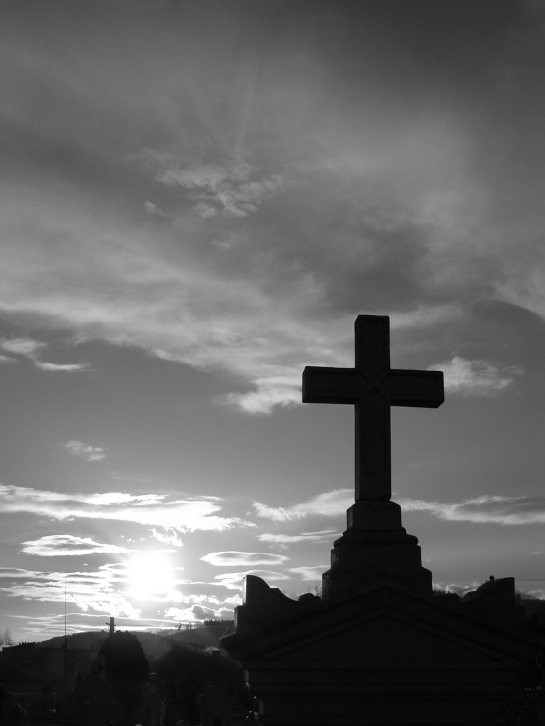 a large wooden cross on top of a wooden building