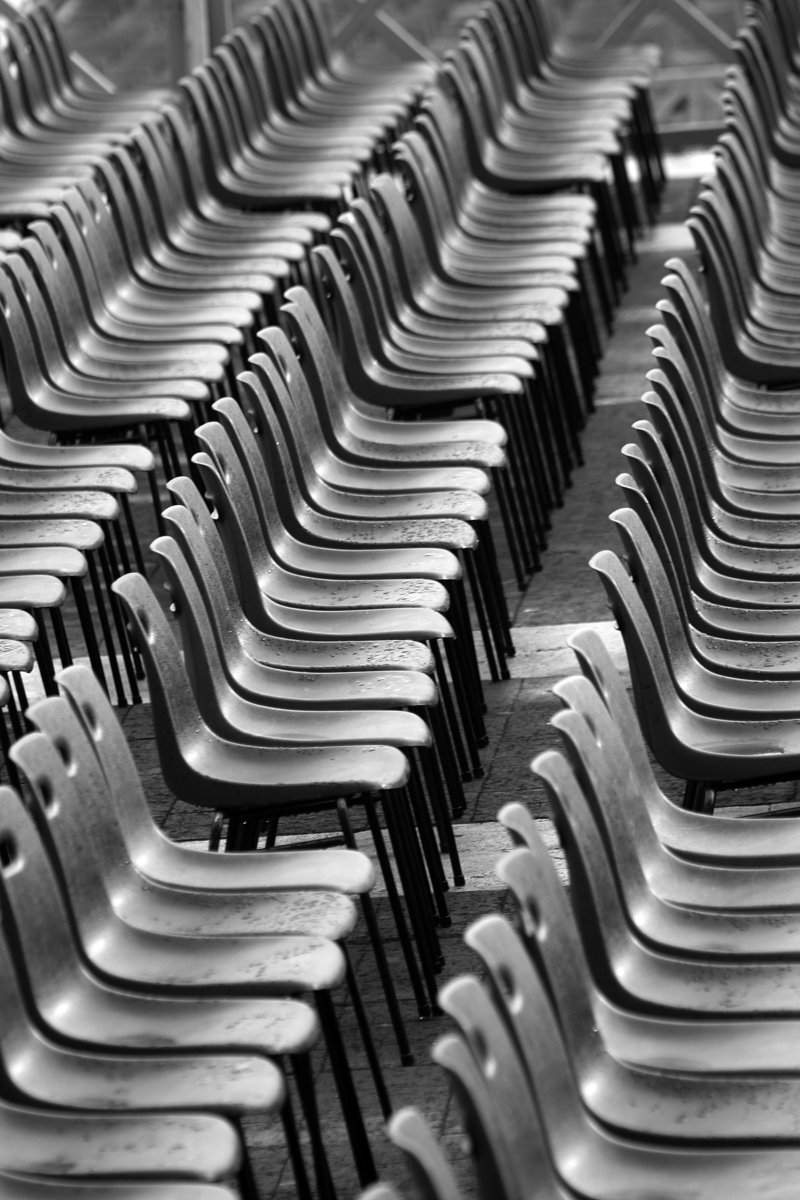 many chairs are lined up in the empty auditorium