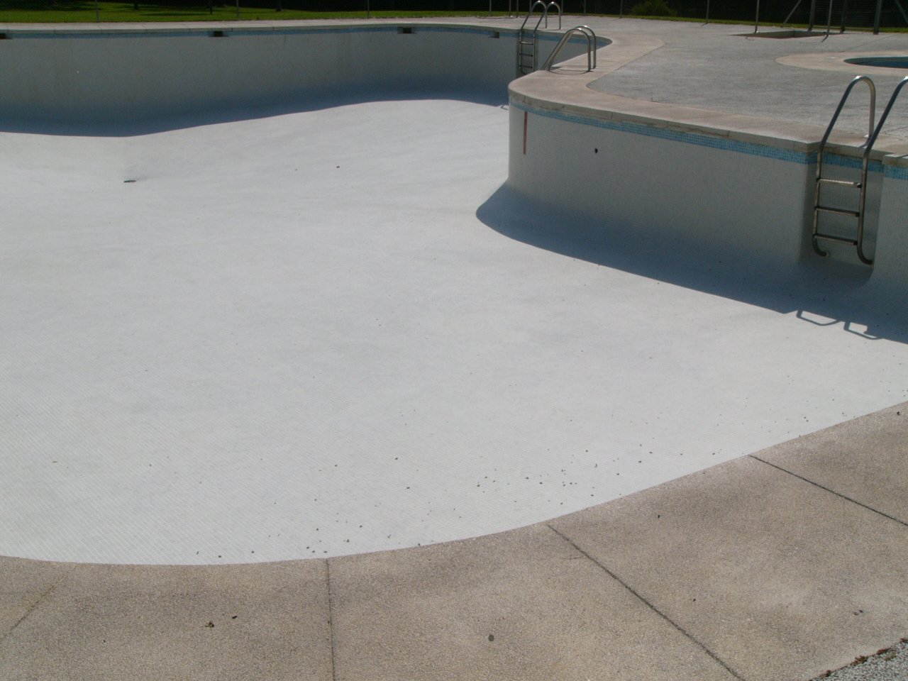 a long empty pool with steps leading to it