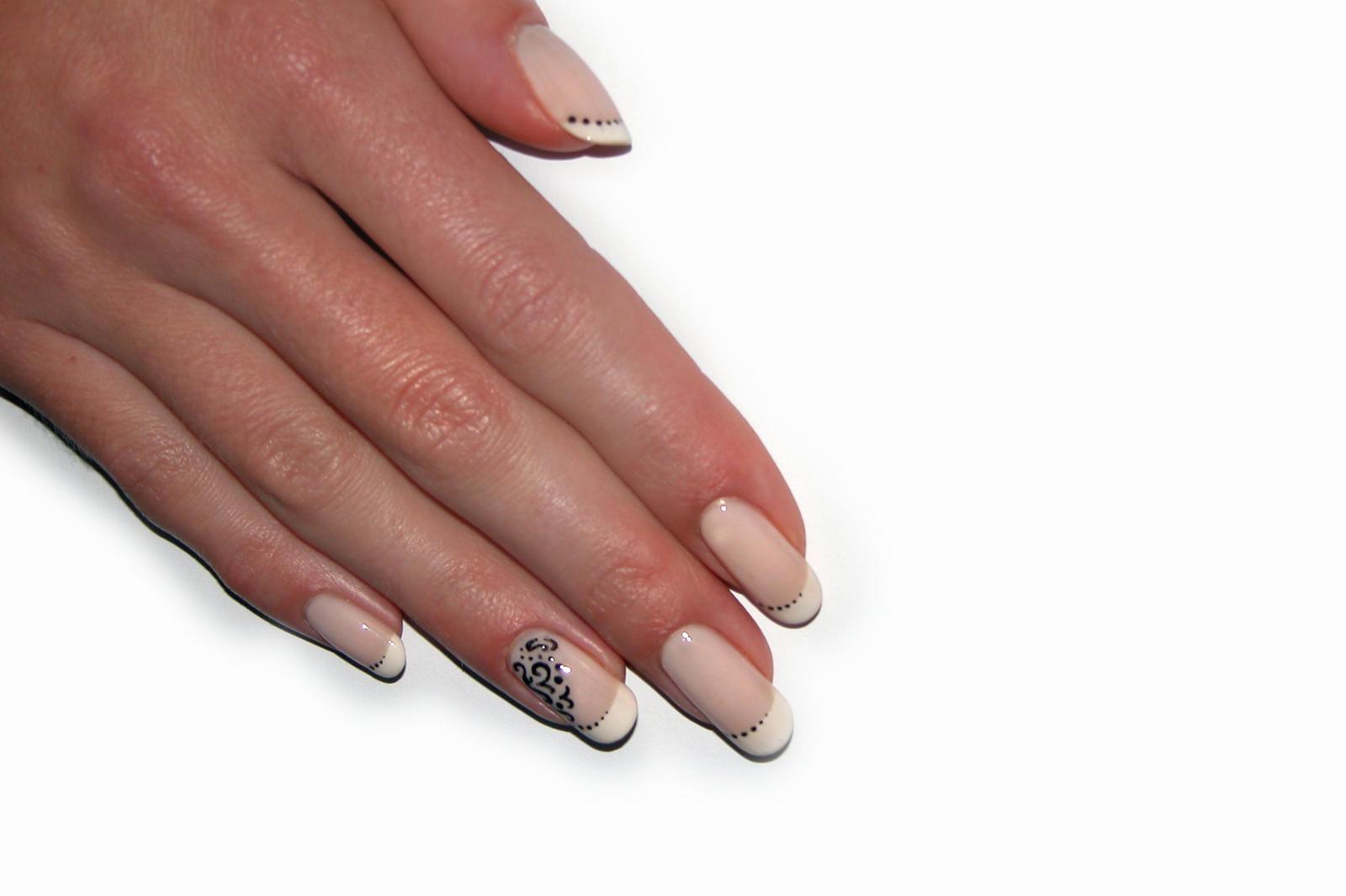 a person's manicured nails with white and black details