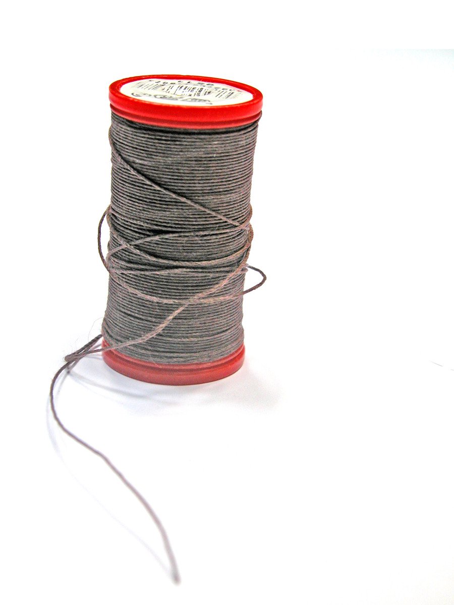 a spool of grey colored thread that is also white thread