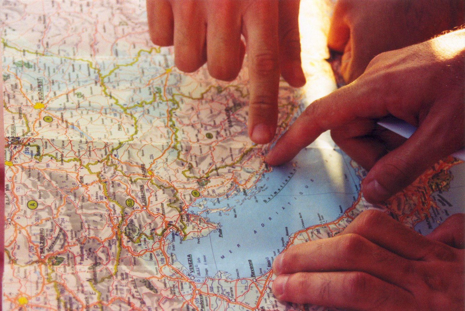 a person pointing at a map with hands
