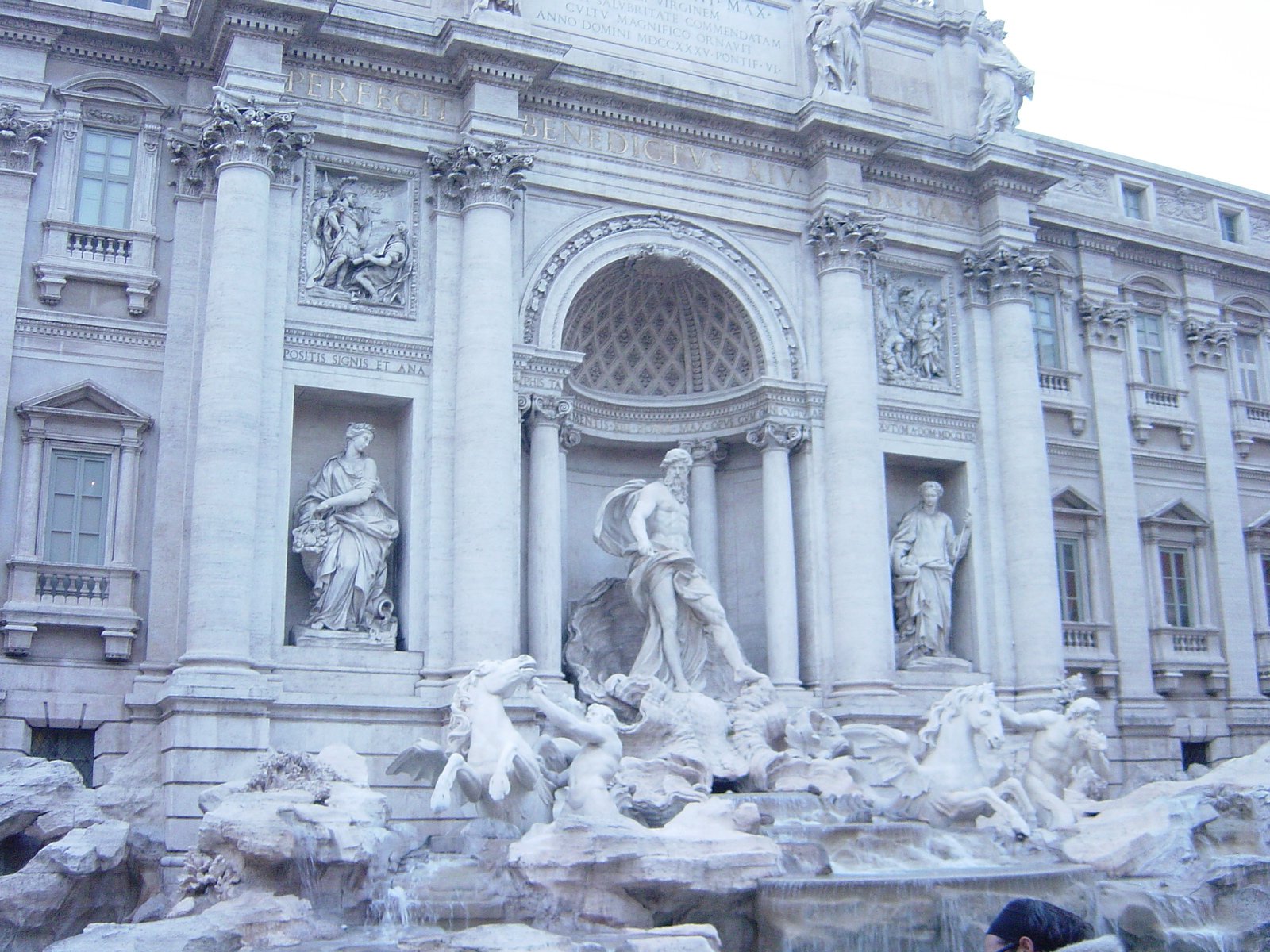 a large stone building with statues on the side