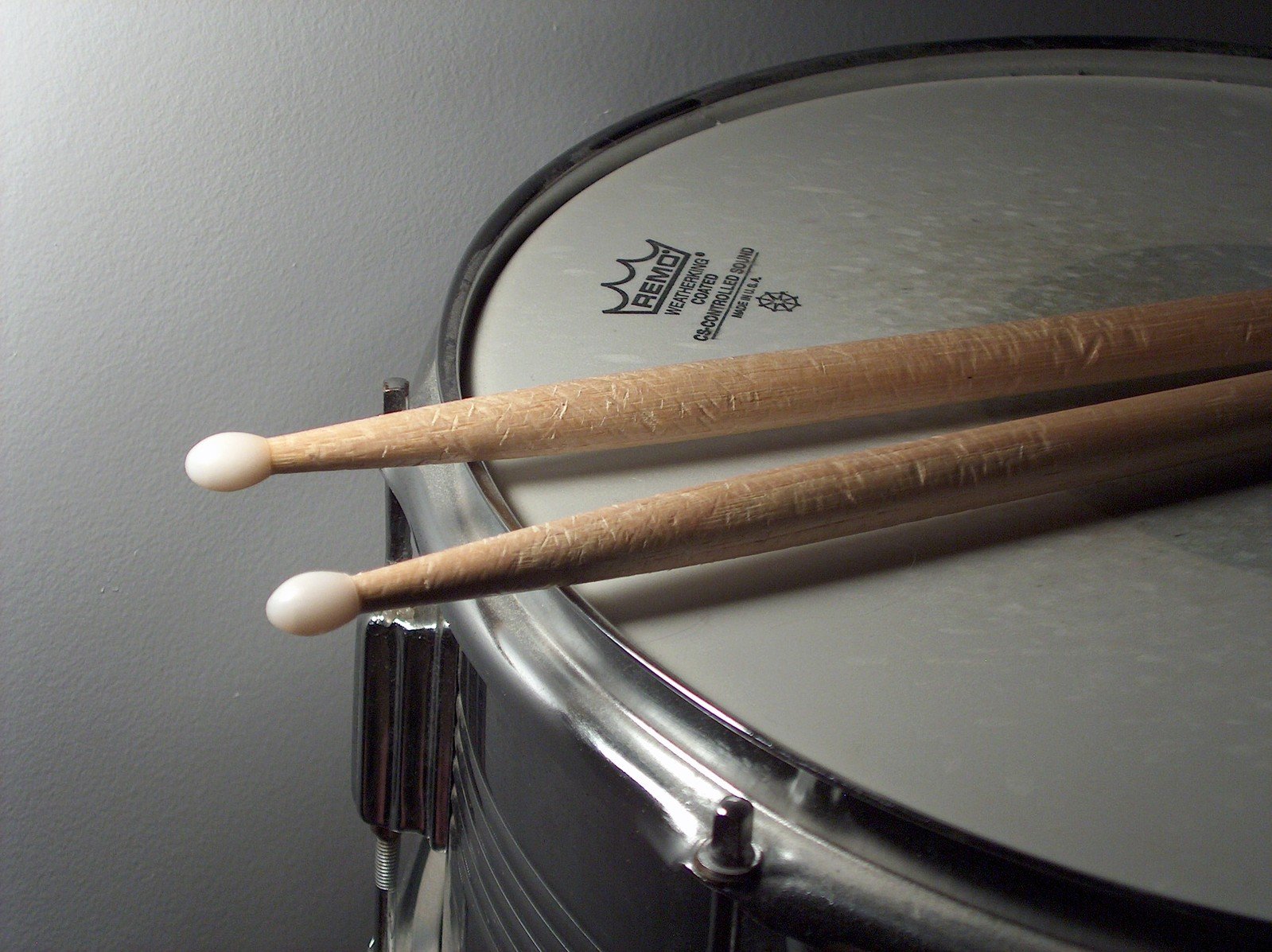 two drums resting on the drum kit with sticks and sticks sticking out of the top of them