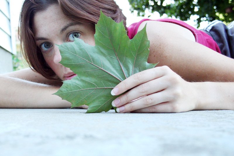 a close up of a person holding a leaf