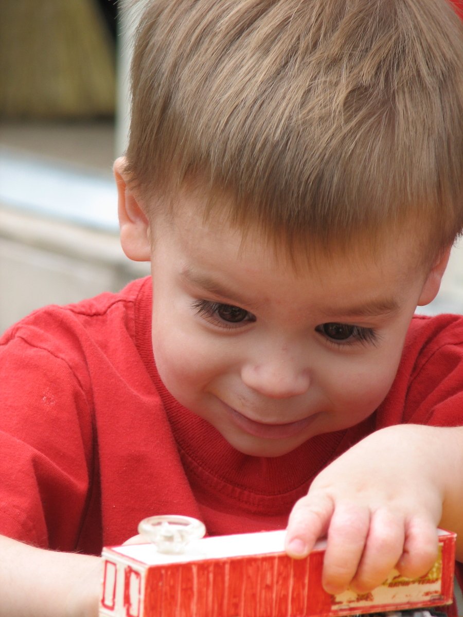 there is a  holding a toy truck