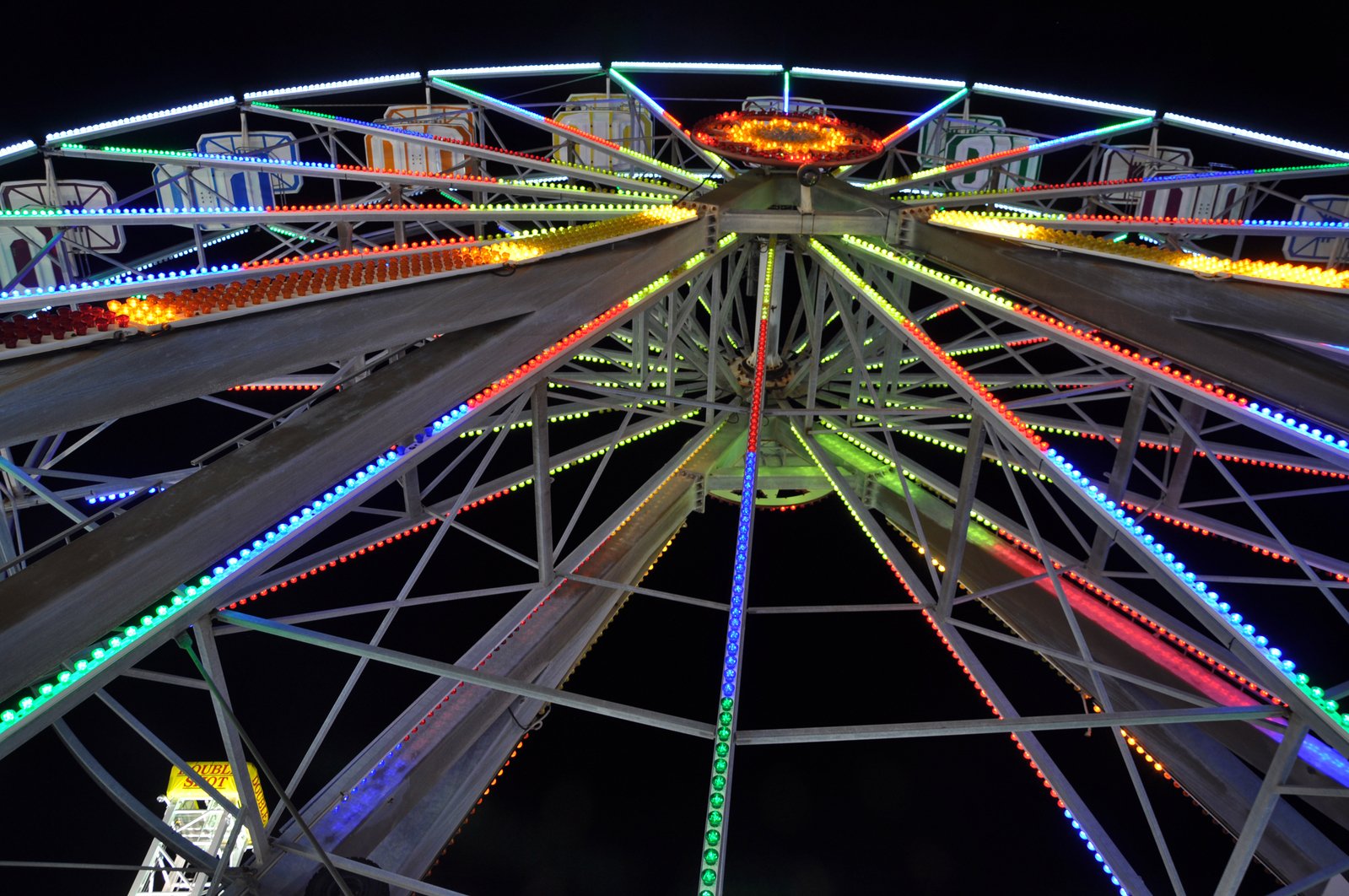 colorful ferris wheel is lit up at night time