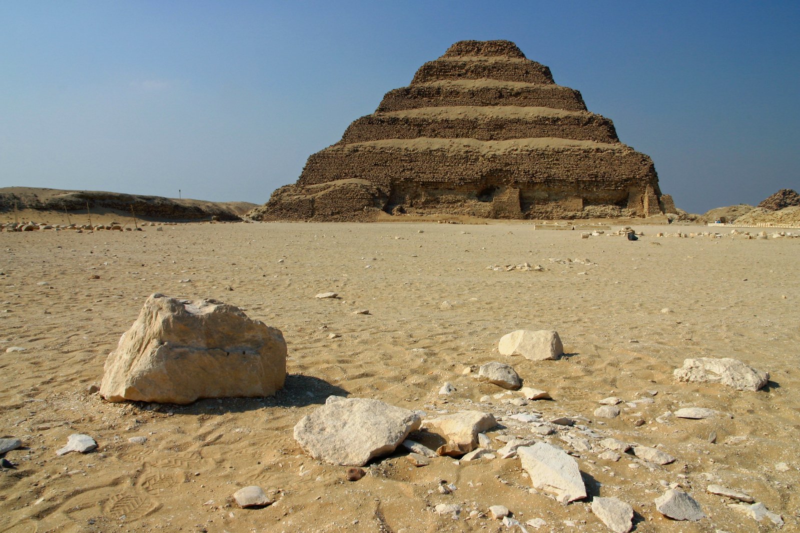 an ancient pyramid set among the rocks and sand