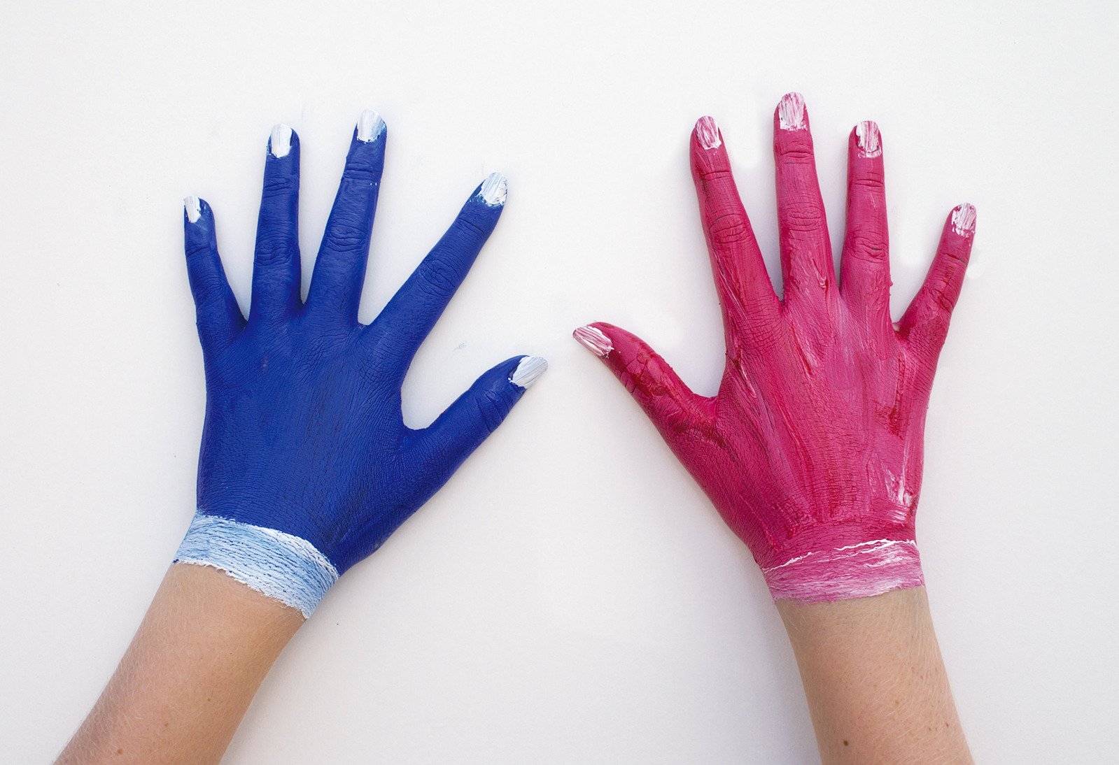 two hands with painted blue and pink gloves on each hand