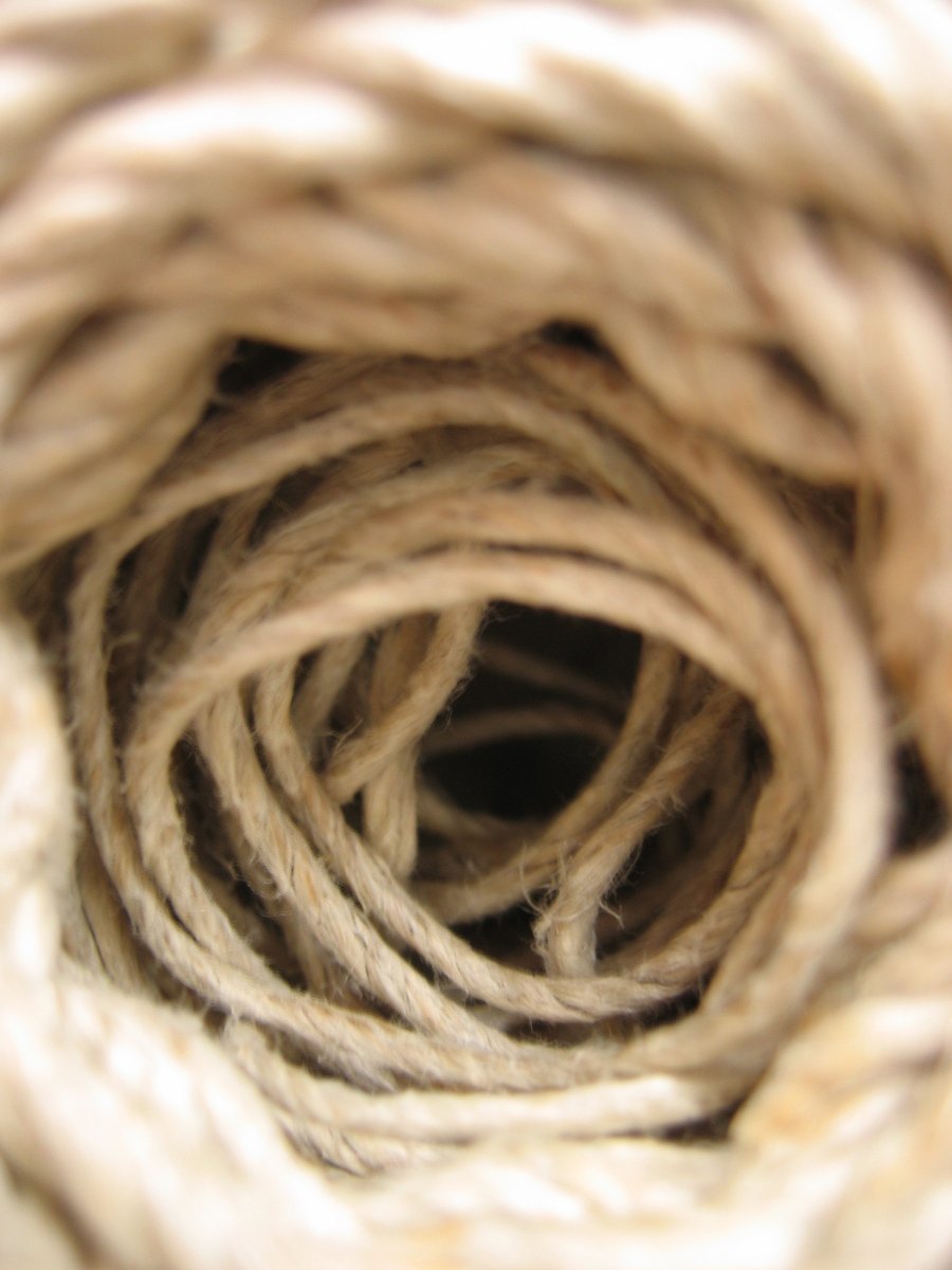 white wool ropes are piled into a ball