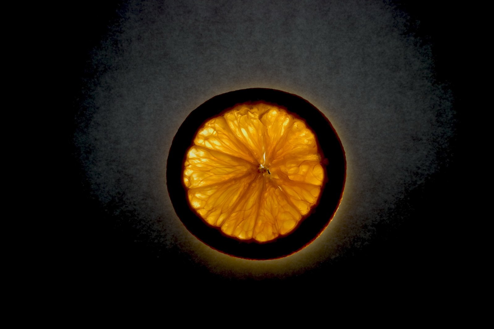 a close - up of a single orange peel on a black background