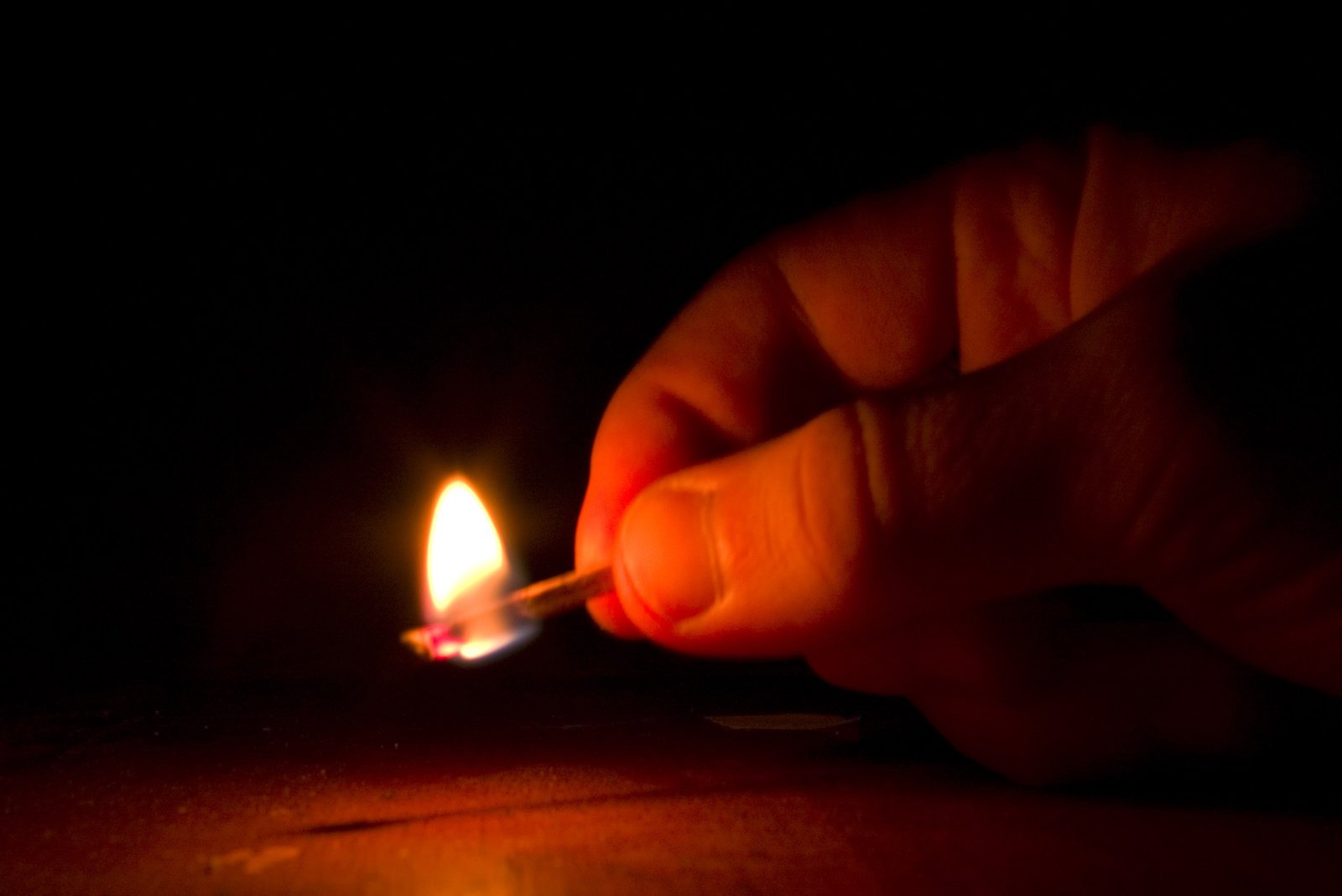 a person lights a match between two matches