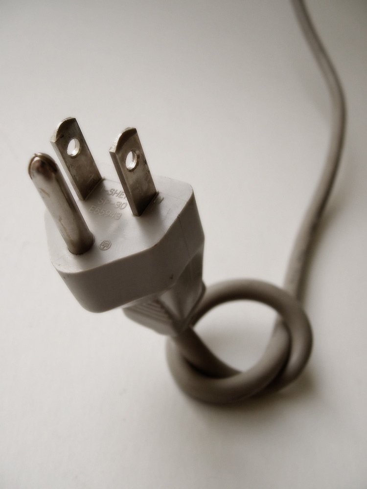 a close up of a electrical plug with a cord