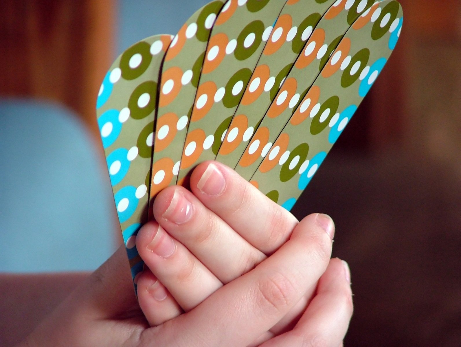 some colored papers held up together in front of a person