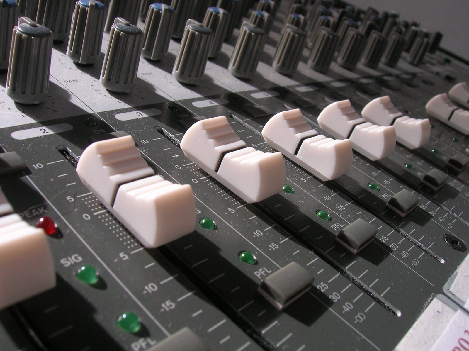 a mixing desk with white ons and green s