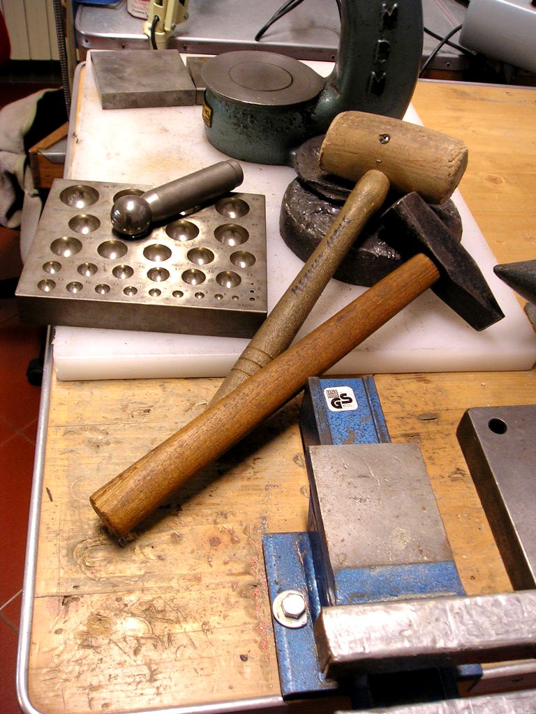 various tools are sitting on a work bench