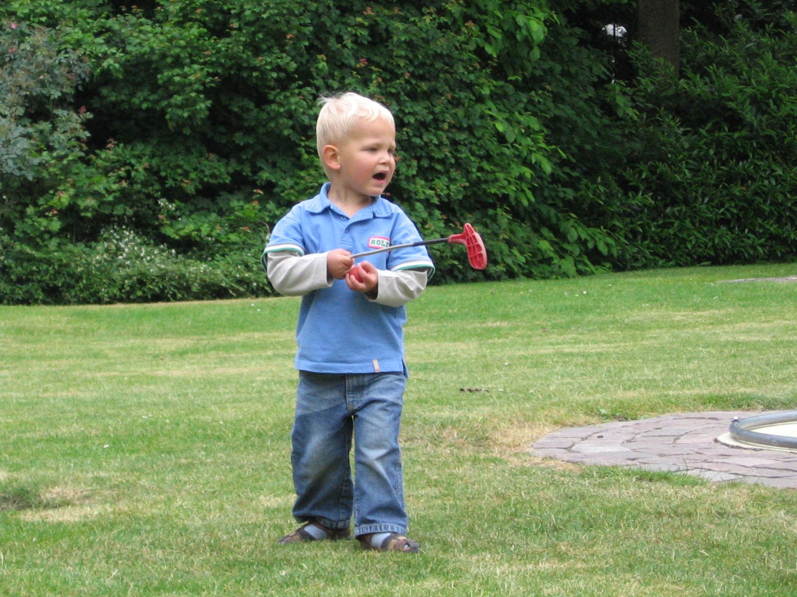 a boy with a toy on the grass