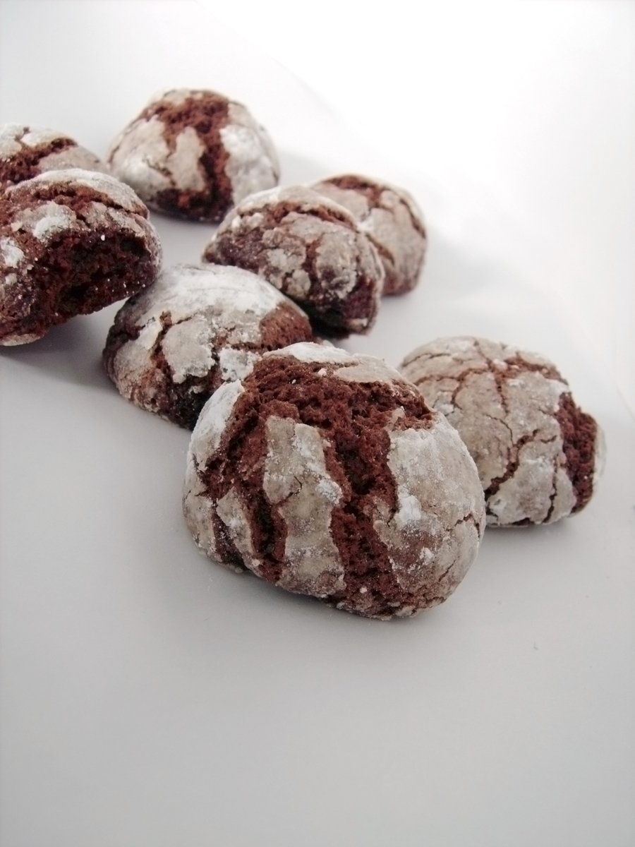 a bunch of brown and white cookies are on a white surface