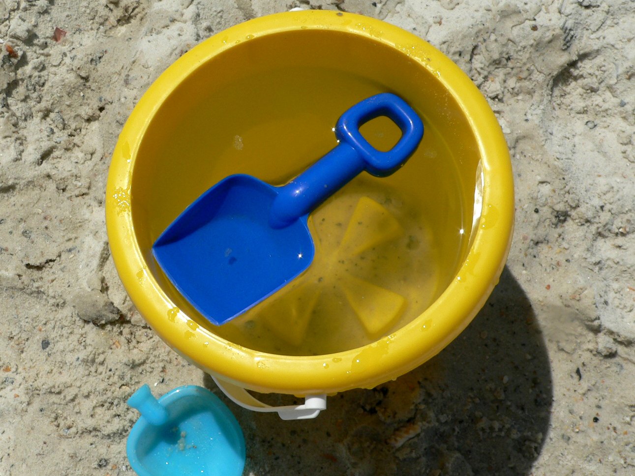 yellow and blue bucket with blue plastic spoon