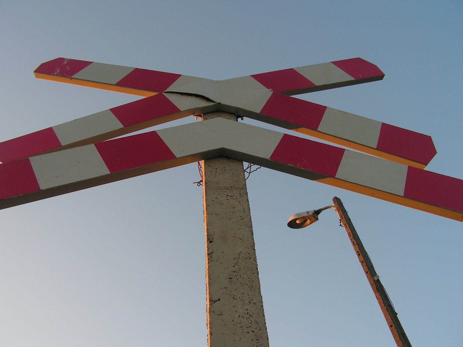 a red and white street sign that has orange and gray strips