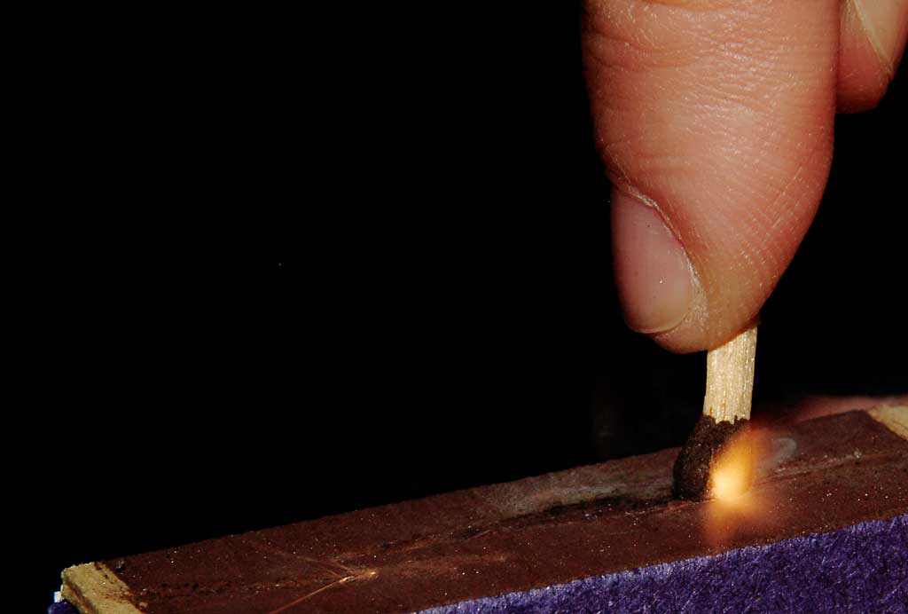 someone placing matches in a square purple box