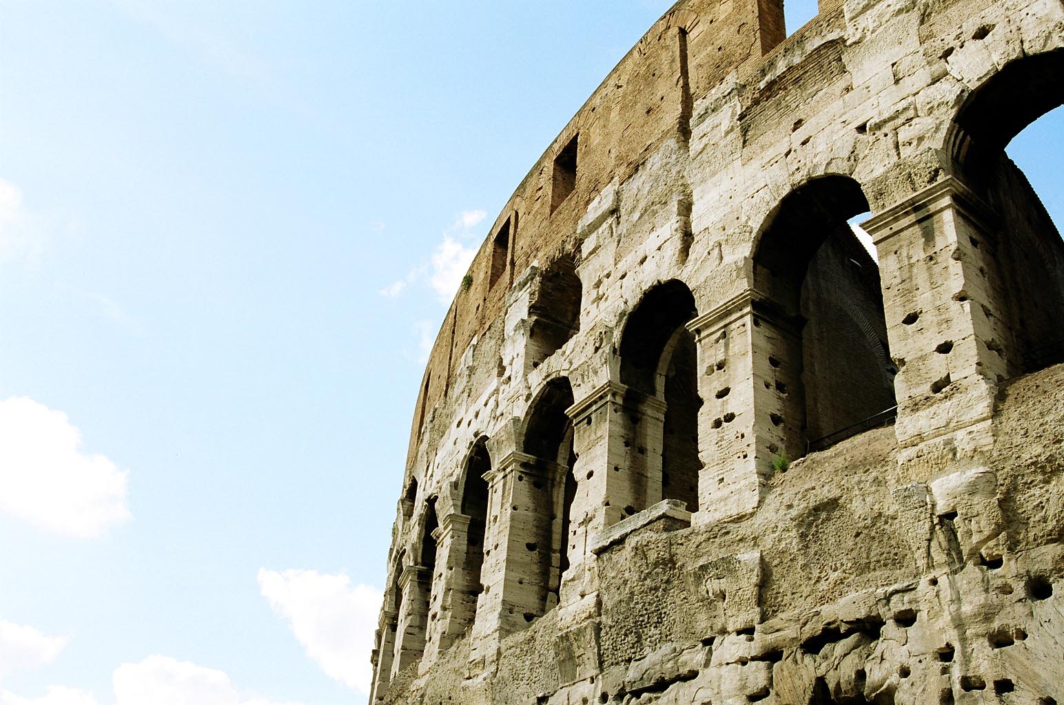 an ancient roman structure with round windows and a clear sky