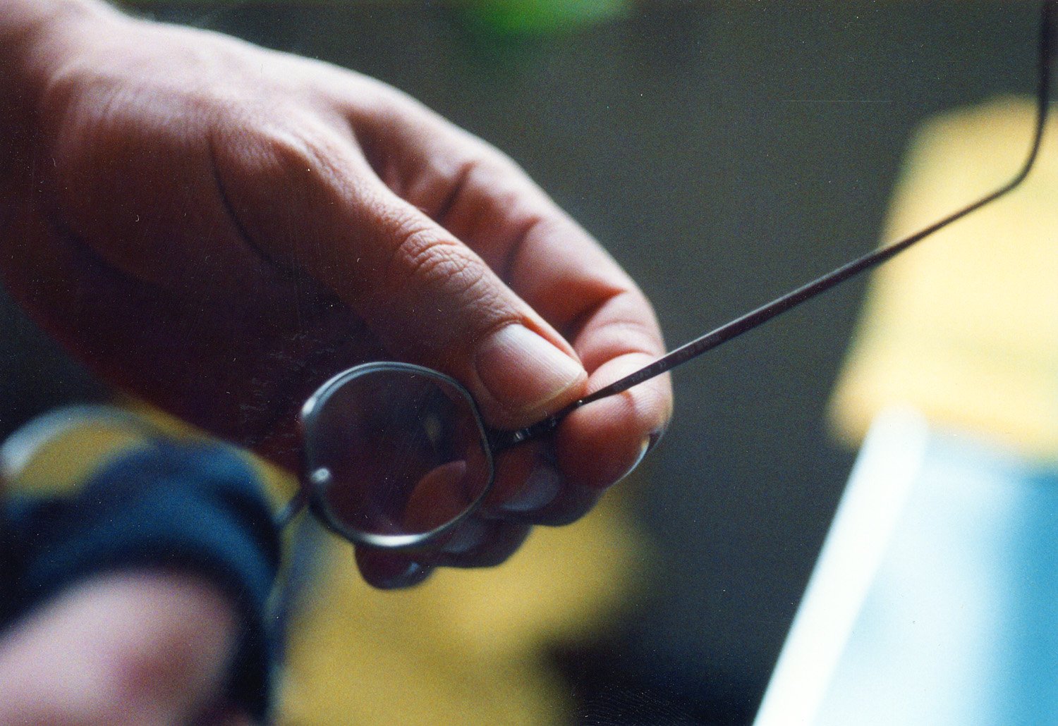 a hand with small scissors inside of it