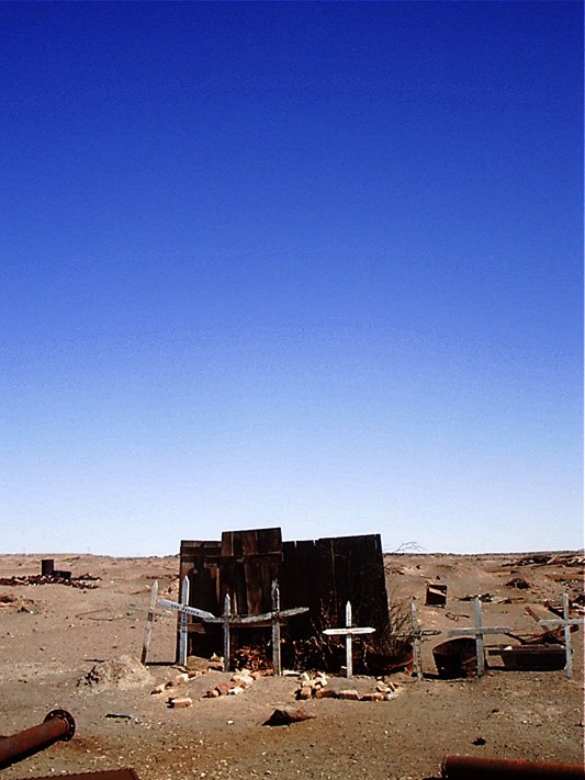 there is a rusted out building with crosses in the middle