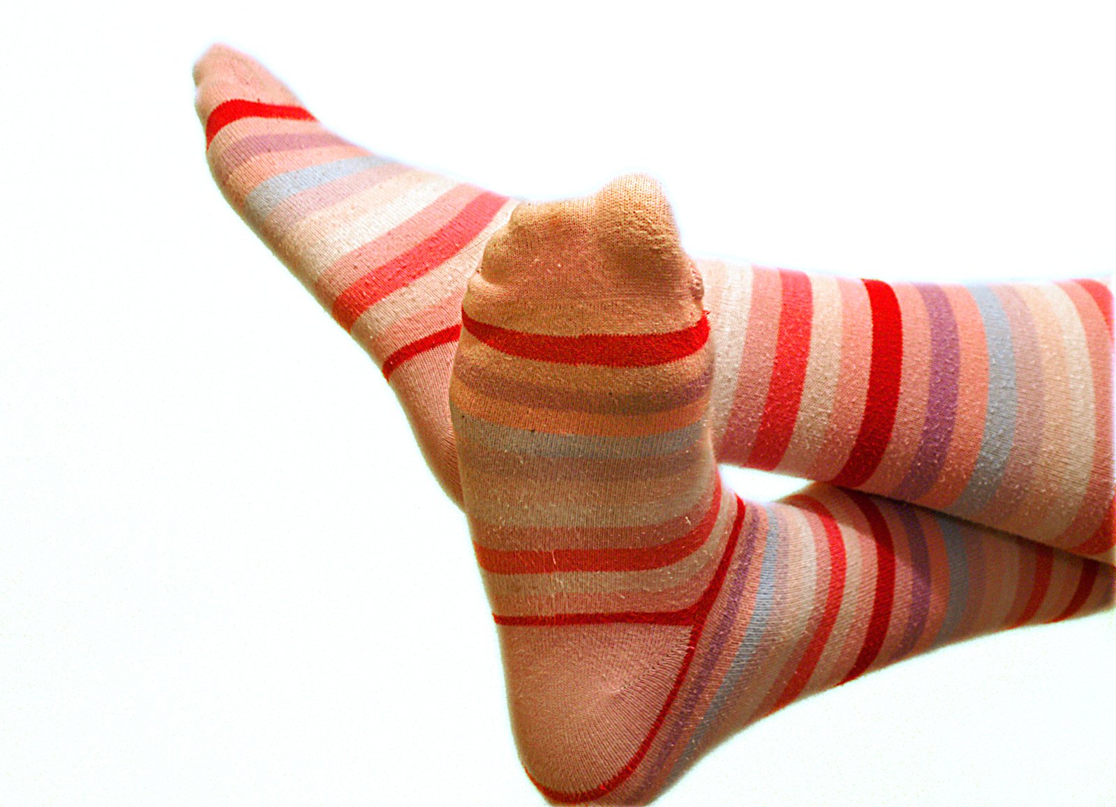 the legs of a woman with colorful striped socks