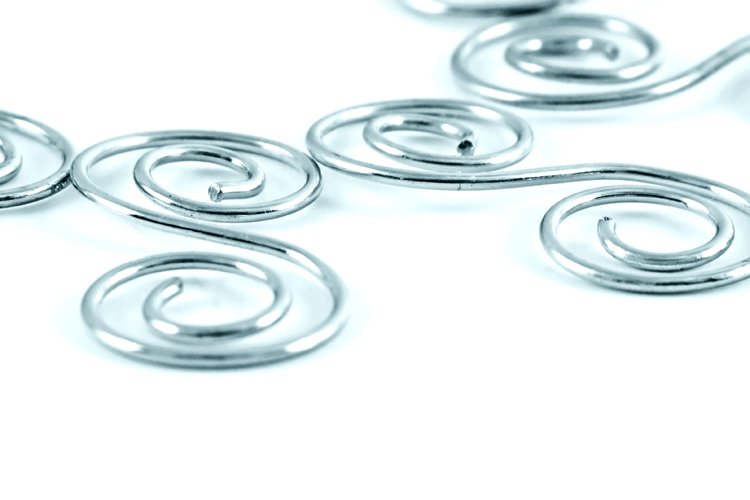 six silver metal spirals laying in the center