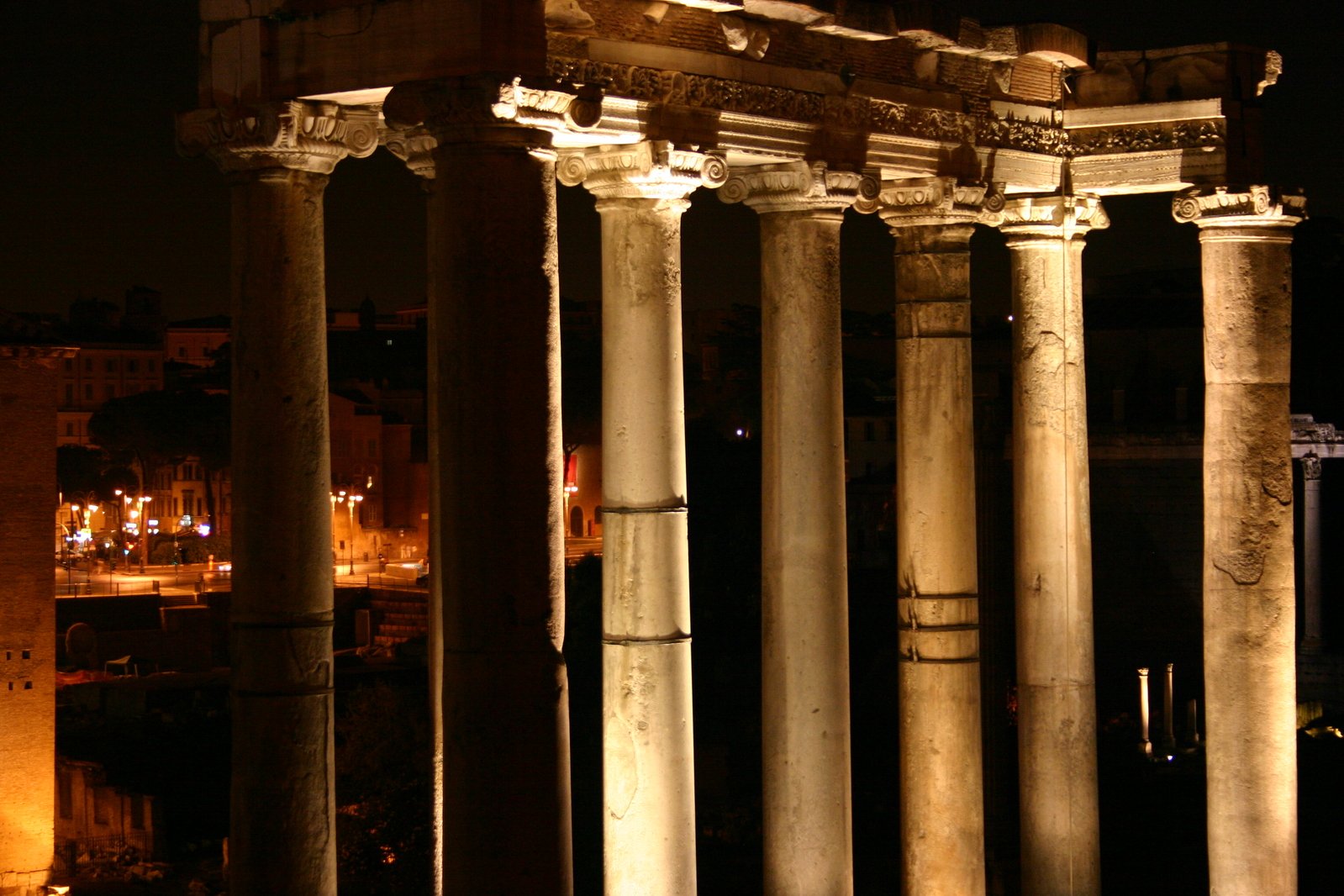 an old roman temple at night with columns