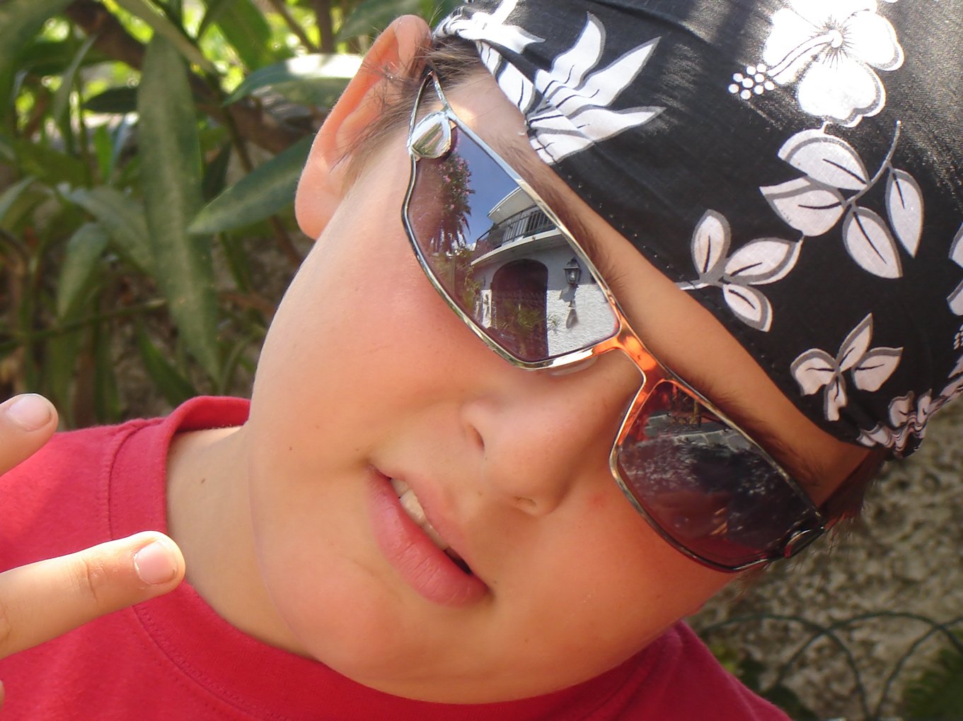 a  wearing sunglasses and a hat