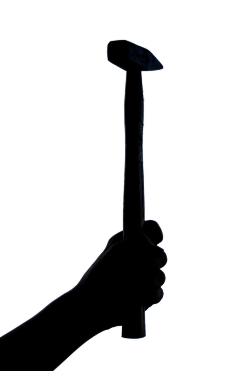 a hammer in hand, a white background