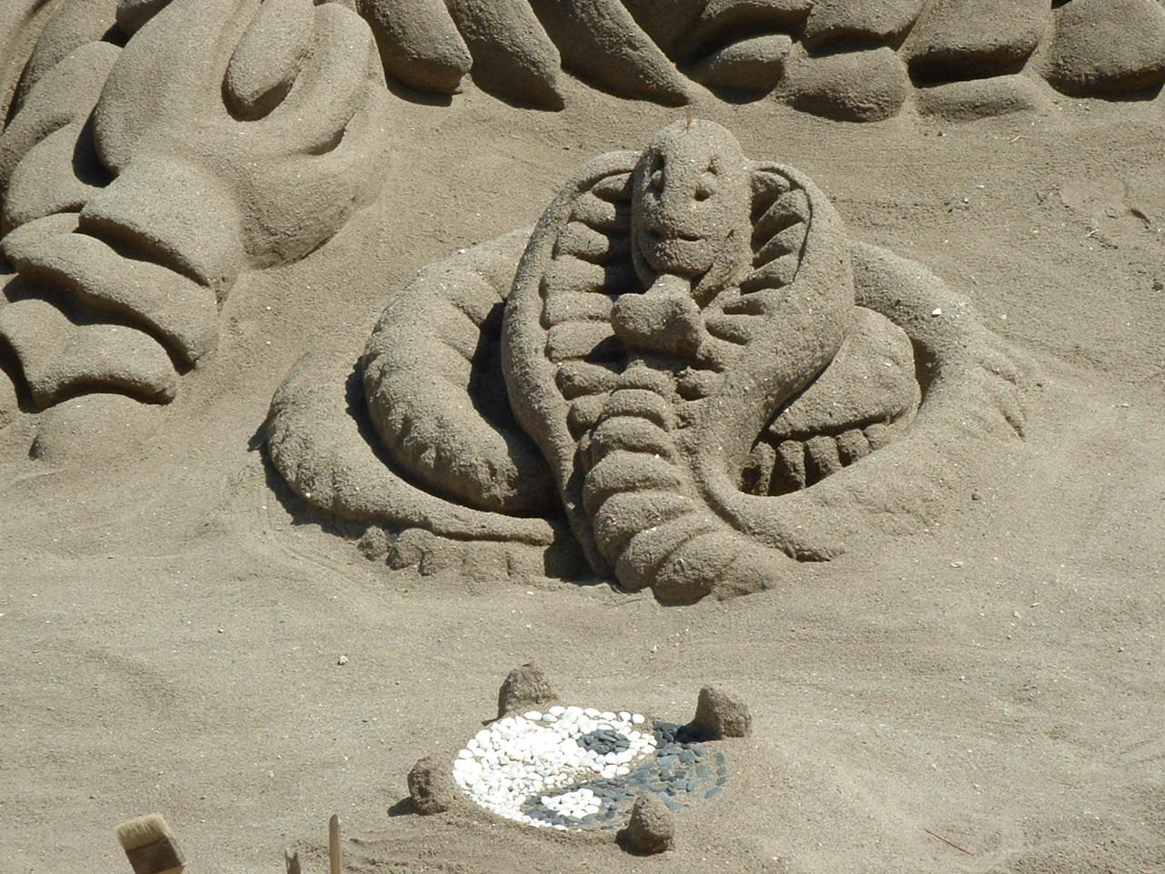 a sand sculpture of an elephant made of human like materials