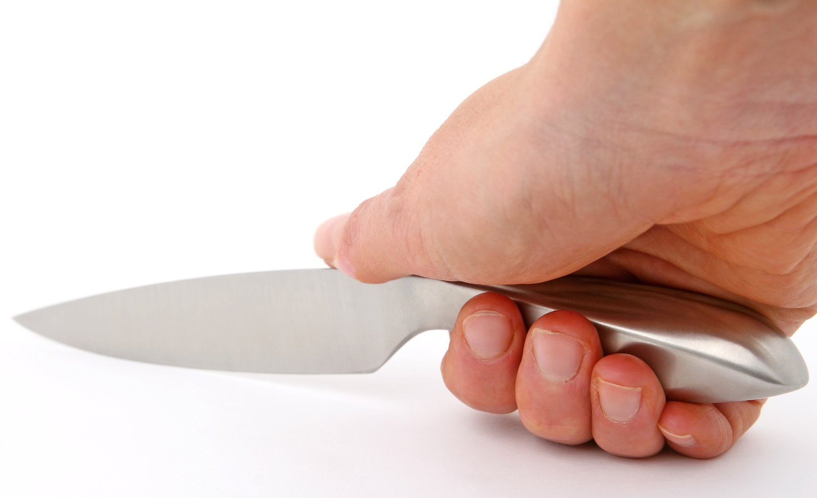 a hand holding a knife on a white background